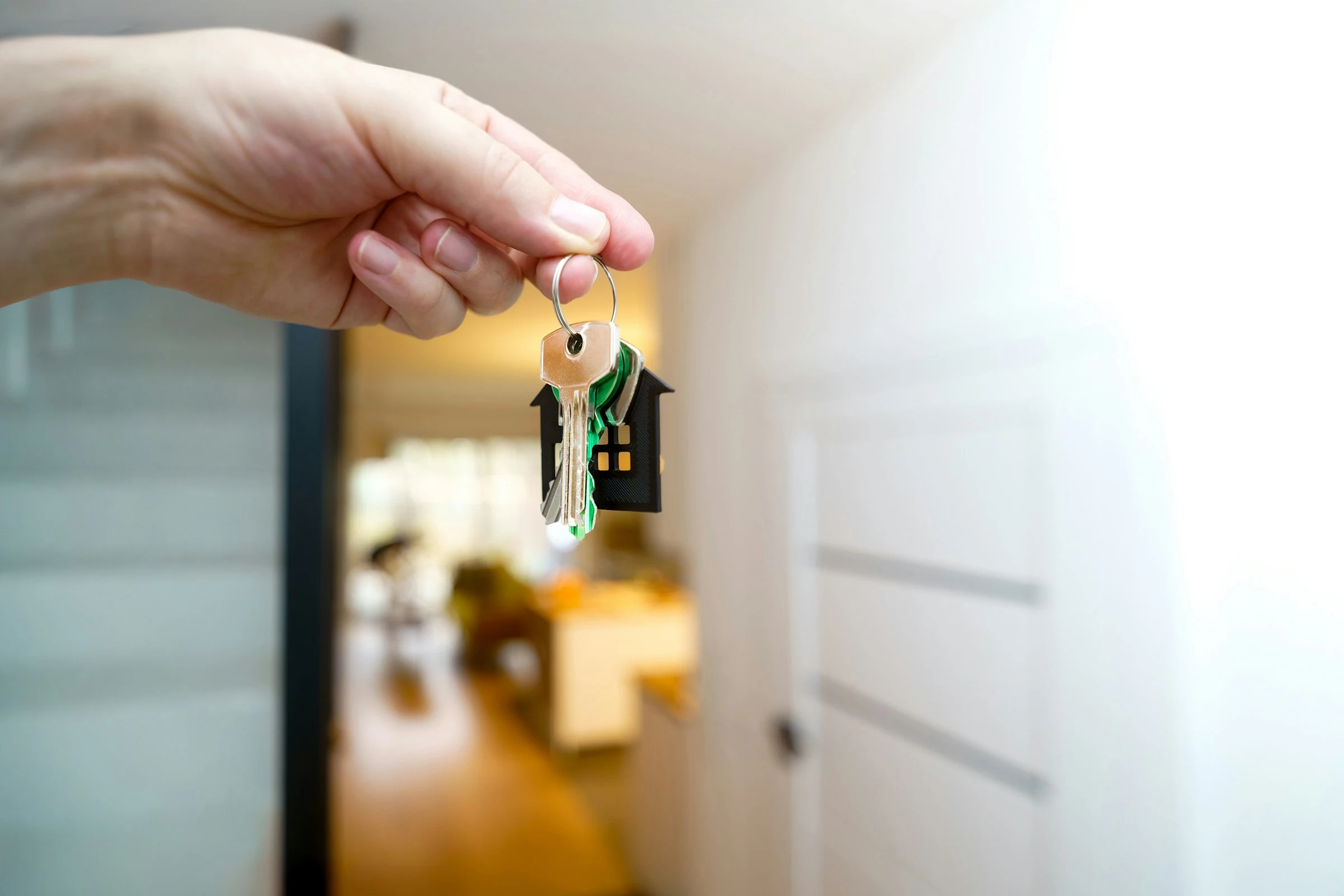 A hand holding the keys to a new home