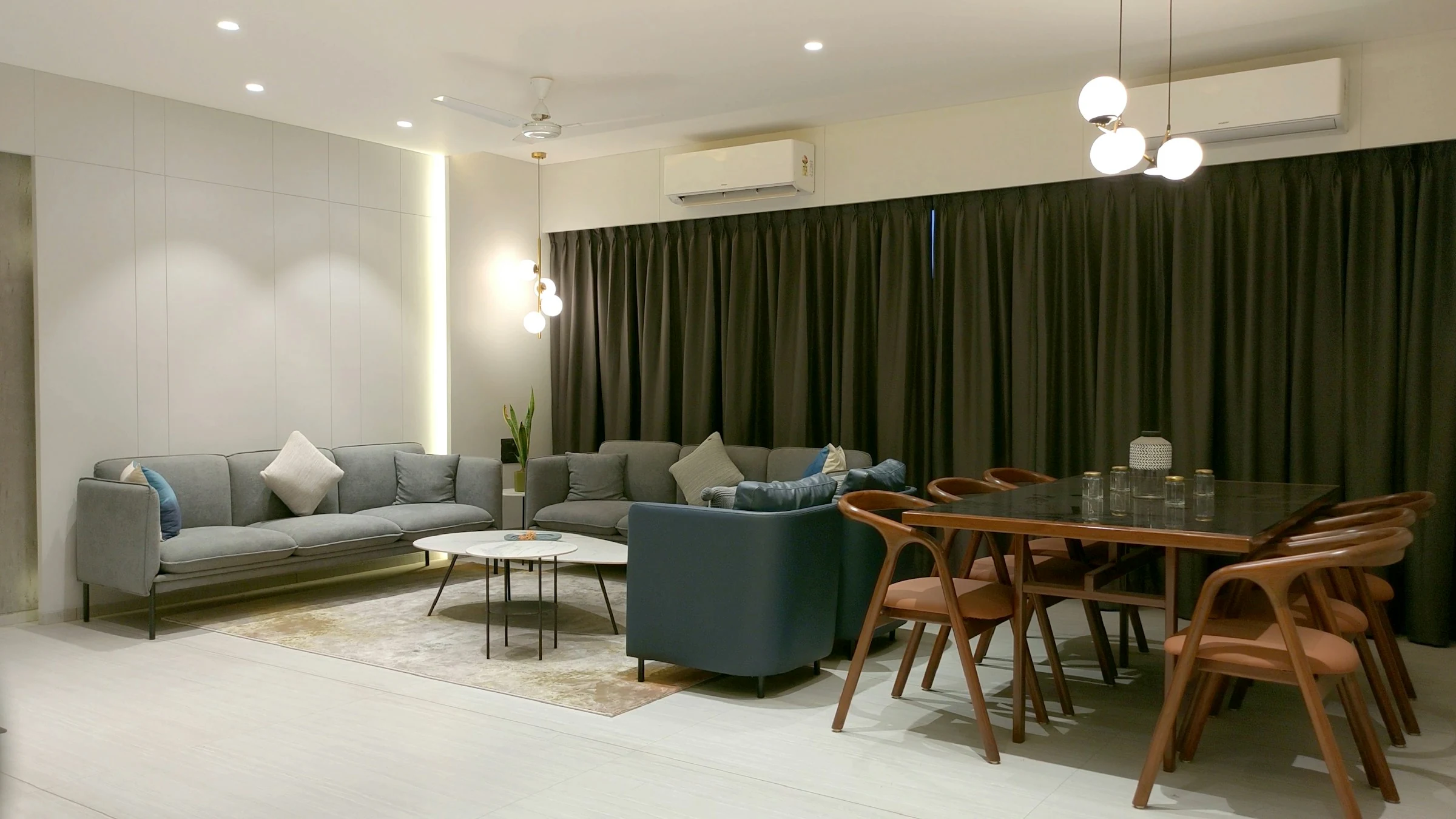 A finished apartment living and dining room, staged for buyers